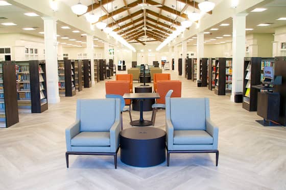 Wide view of rows of seating between book shelves