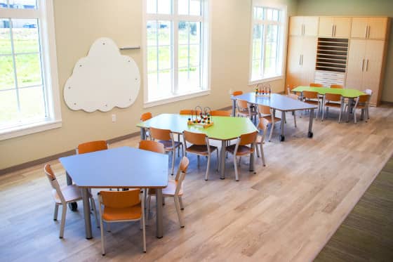 Pentagonal tables arranged by exterior windows