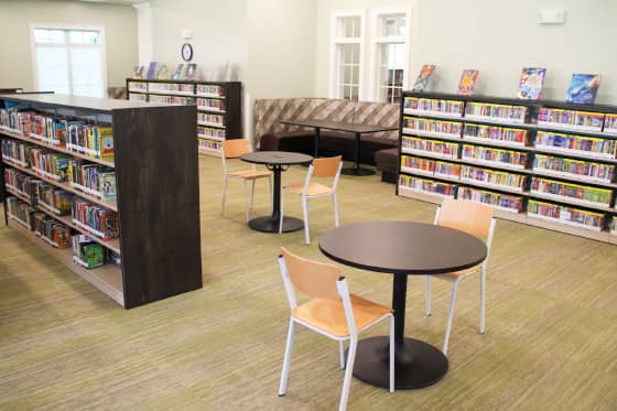 Low bookshelves with small two-seat tables