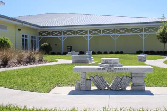 Granite book benches with iconic book titles in garden space